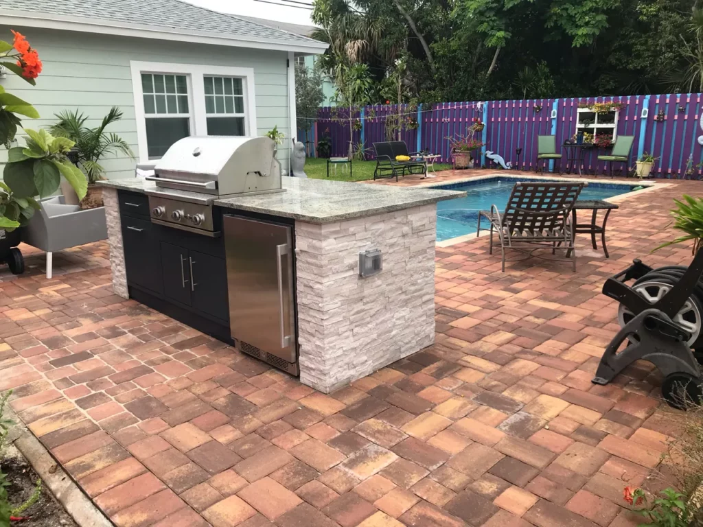 Outdoor kitchen with grill and cabinets