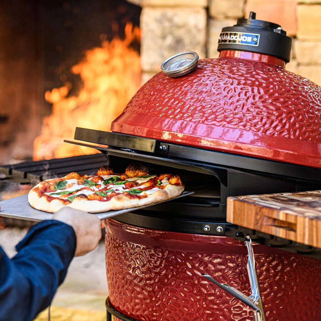 Putting a pizza into a Kamado Joe