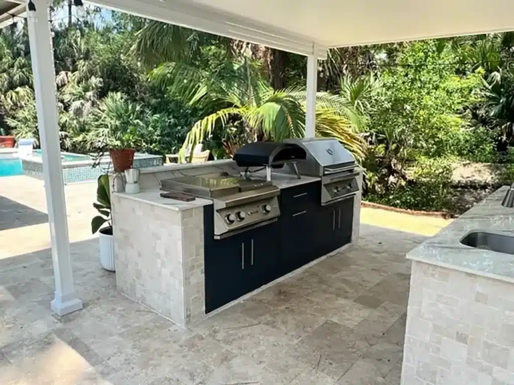 Modern outdoor kitchen with pergola near pool featuring built in grill and countertop space