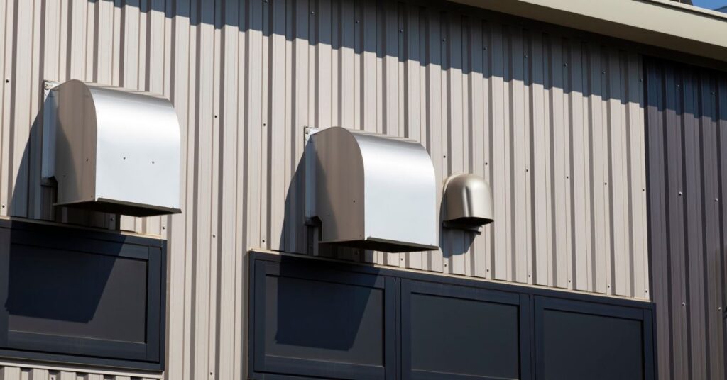 Outdoor kitchen ventilation hood installed on exterior wall for proper airflow